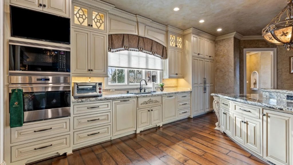 Elegant kitchen with cream cabinetry, granite countertops, and stainless steel appliances.