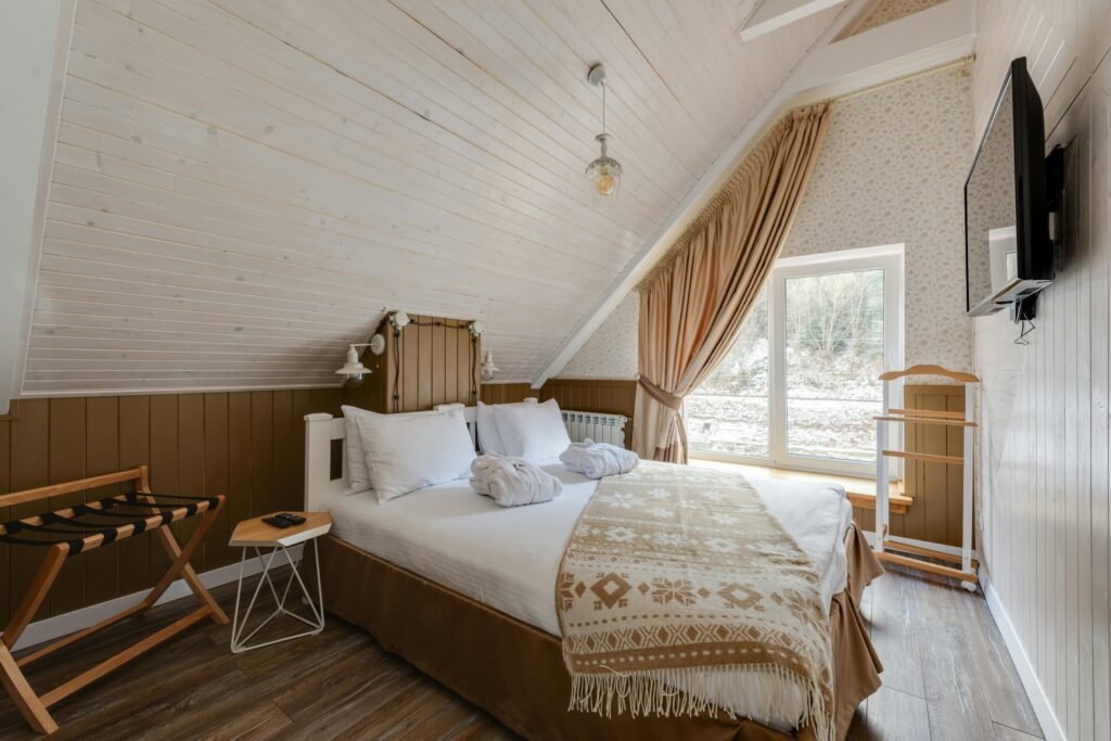 An attic bedroom with neutral colors.