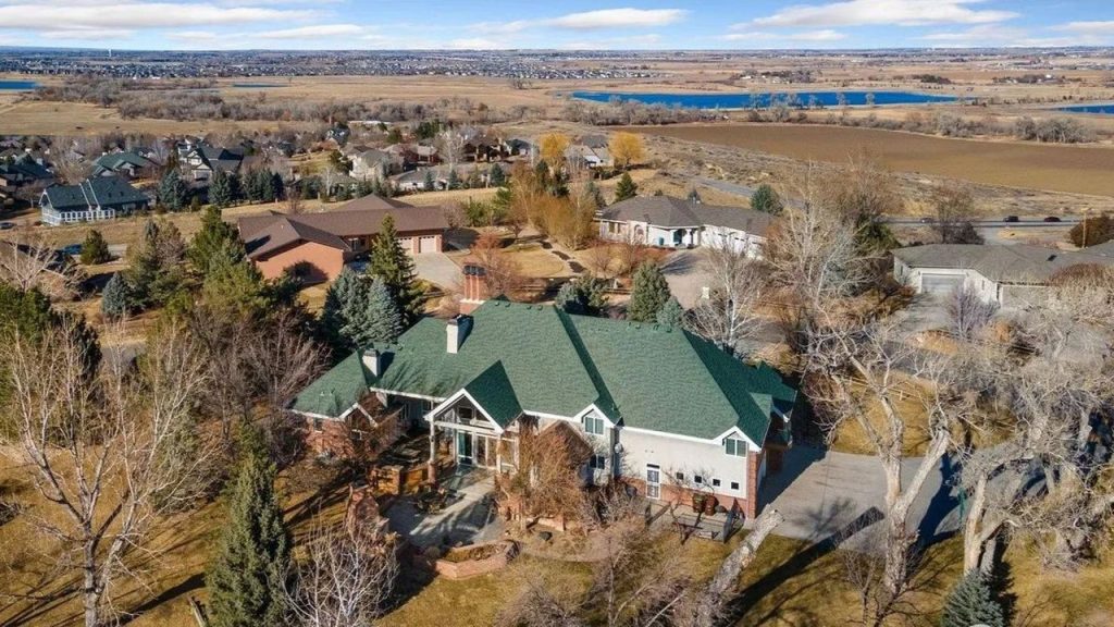 Get Inspired by This Grand 9,523 Sq-Ft Brick Manor in Fort Collins With Curved Staircase, Cherrywood Office, and Vaulted Ceilings