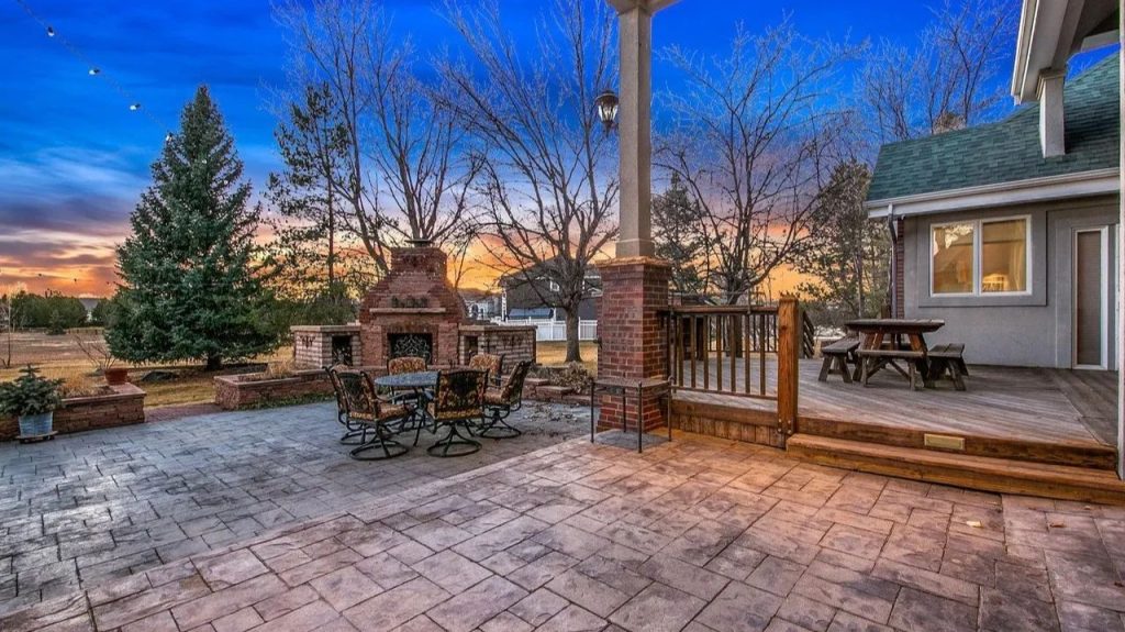 Get Inspired by This Grand 9,523 Sq-Ft Brick Manor in Fort Collins With Curved Staircase, Cherrywood Office, and Vaulted Ceilings
