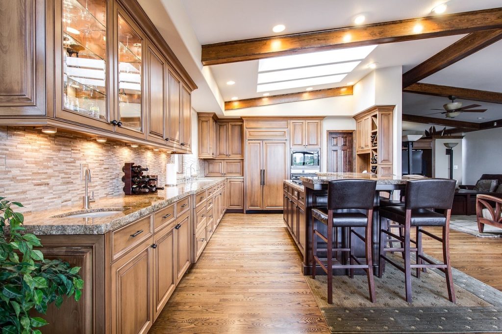 A kitchen with wood tones and skylights.