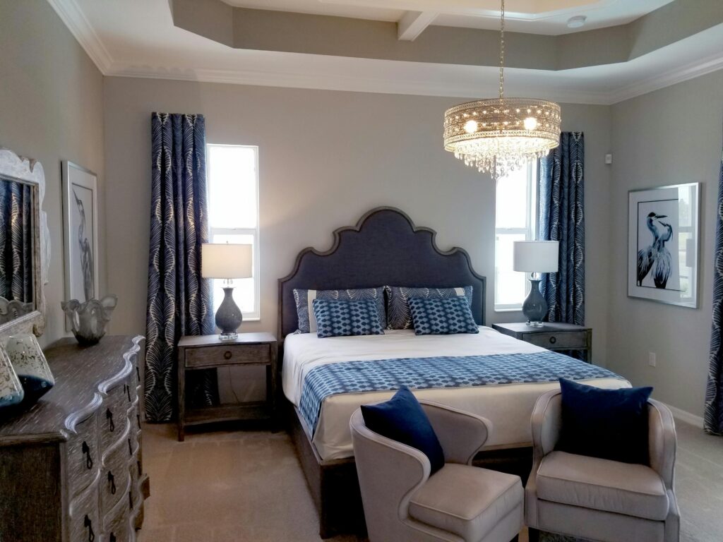  A bedroom with large furniture and blue accents.
