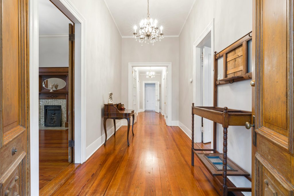 A classical hallway with hardwood floors.
