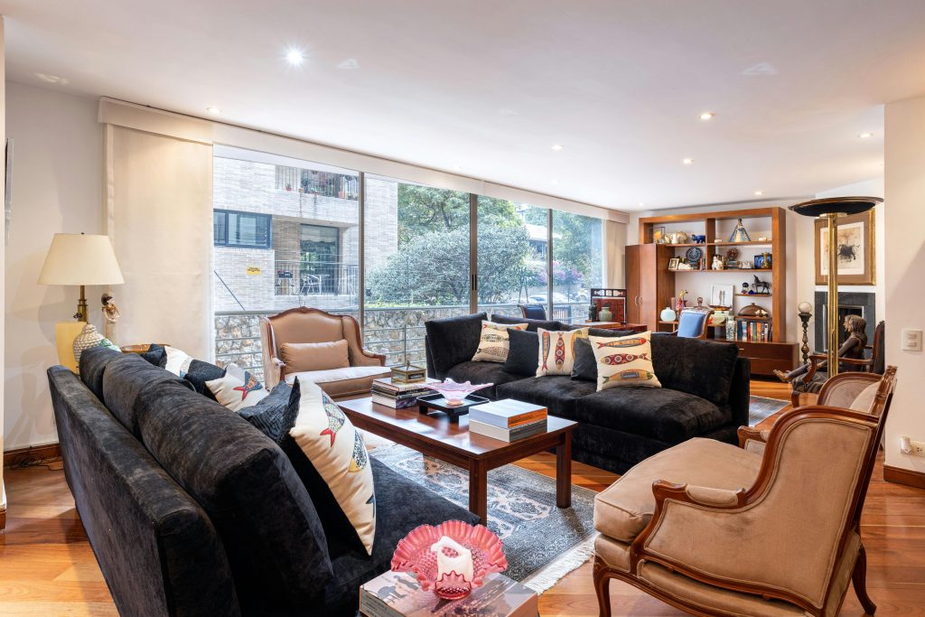 A messy living room that looks dated.
