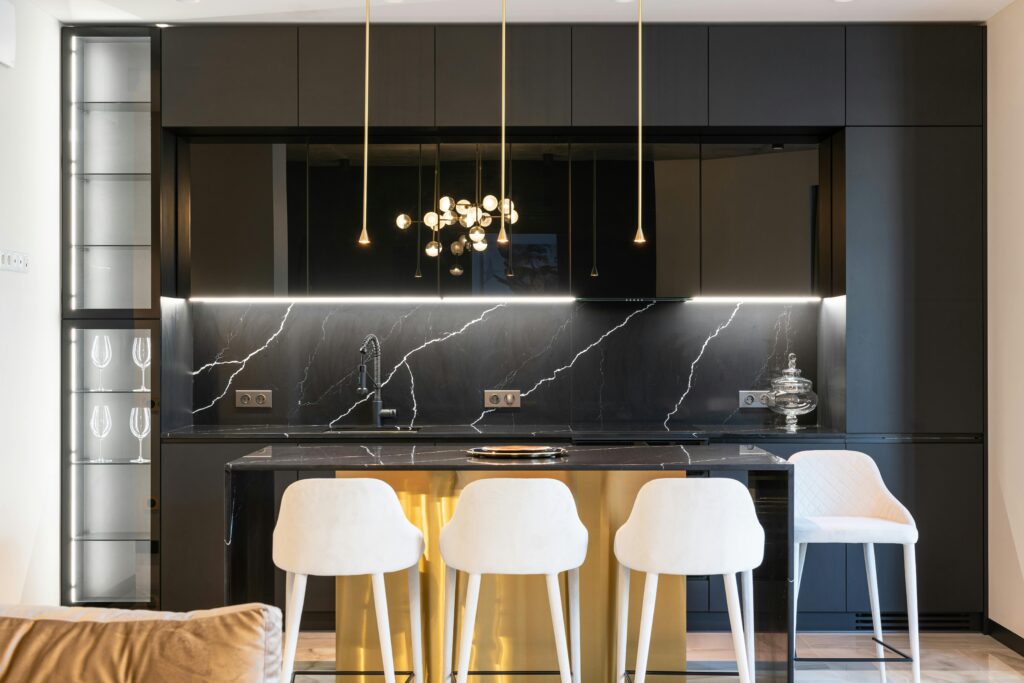 A black kitchen with gold accents.