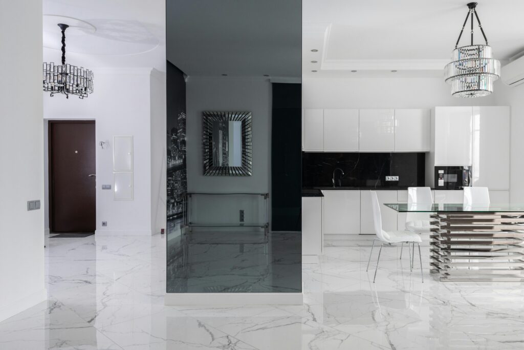 A black and white living room with marble flooring.