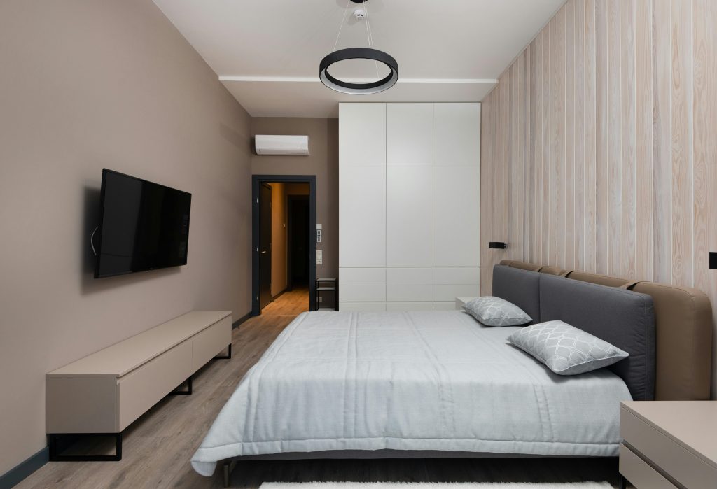 A minimalist bedroom with a large wardrobe.