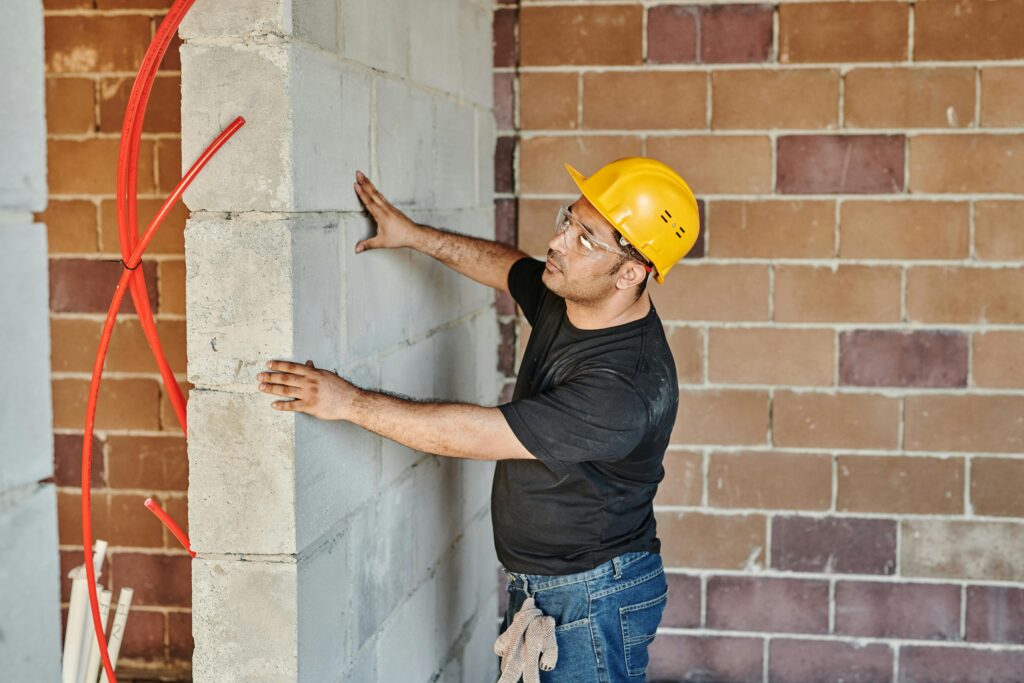 A worker inspecting a wall.