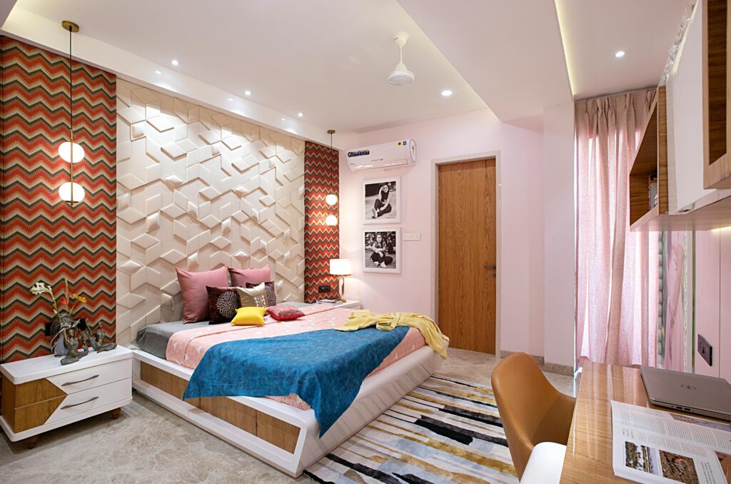 A pink bedroom with clashing patterns.