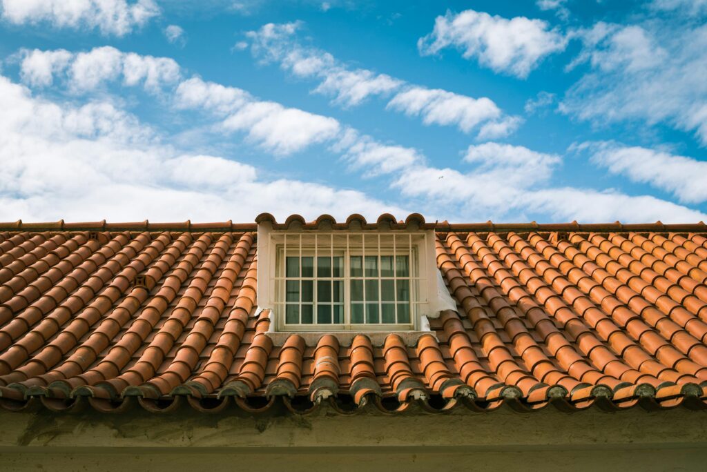 A red-tiled roof with a dormer window.