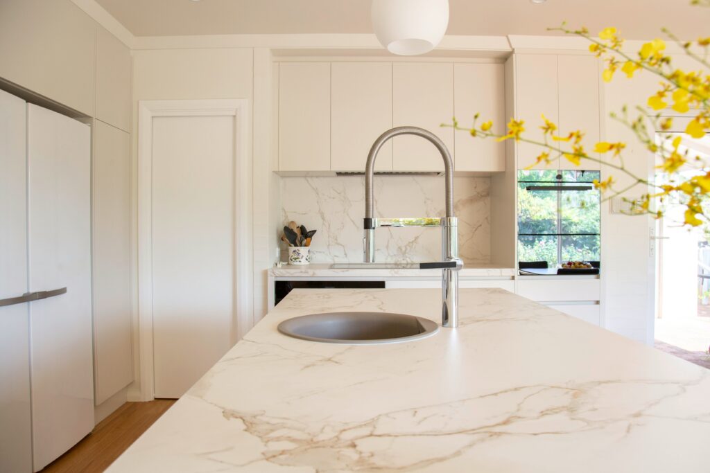 A kitchen with a marble countertop.