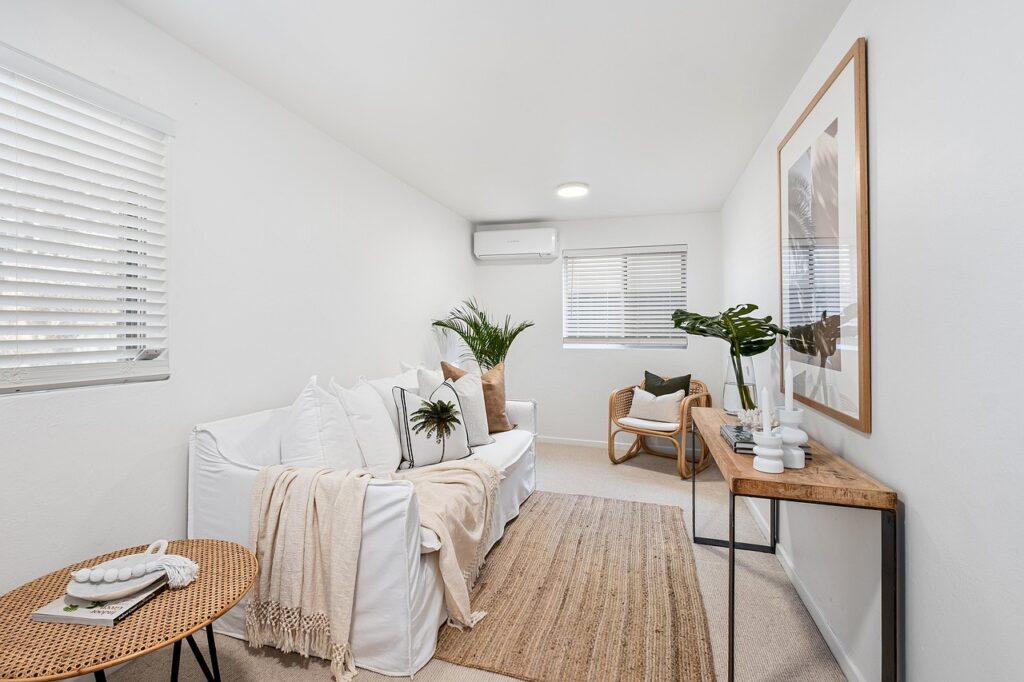A living room with a woven rug and other natural materials.