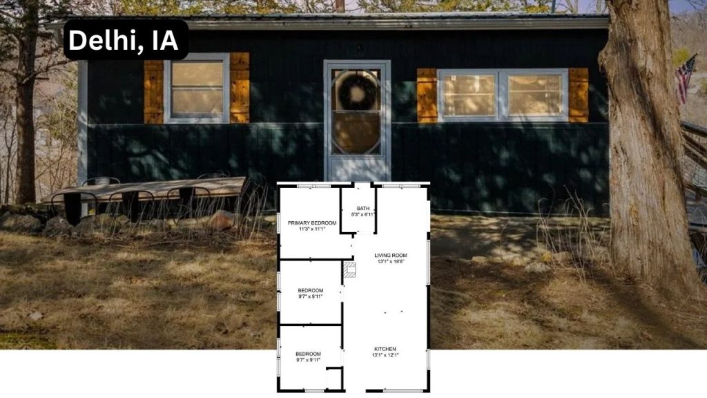 A cozy, rustic 3-bedroom cabin in Delhi, IA, with a dark wood exterior and warm-toned shutters.