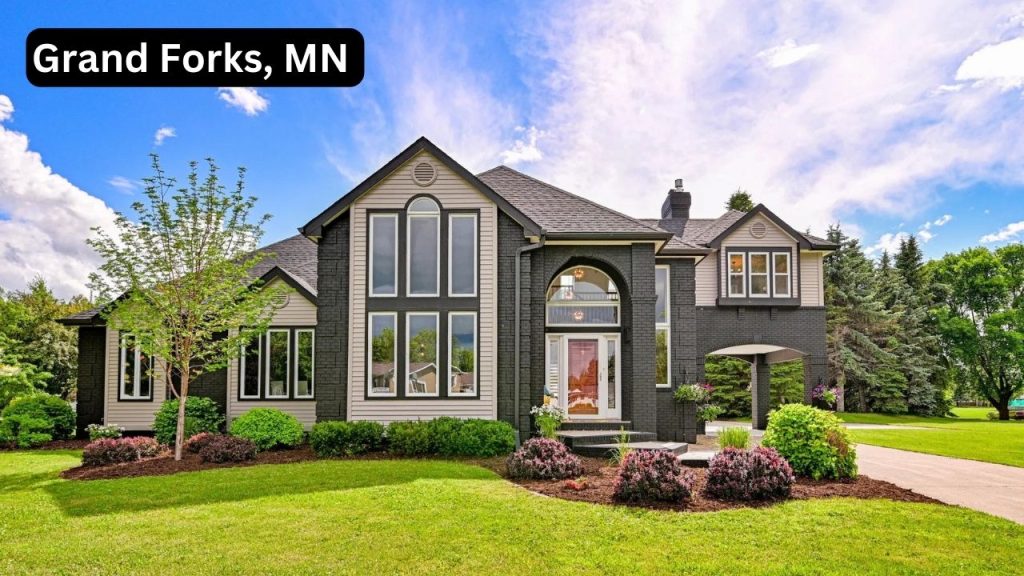 Large modern home with dark exterior and tall windows in East Grand Forks, MN.