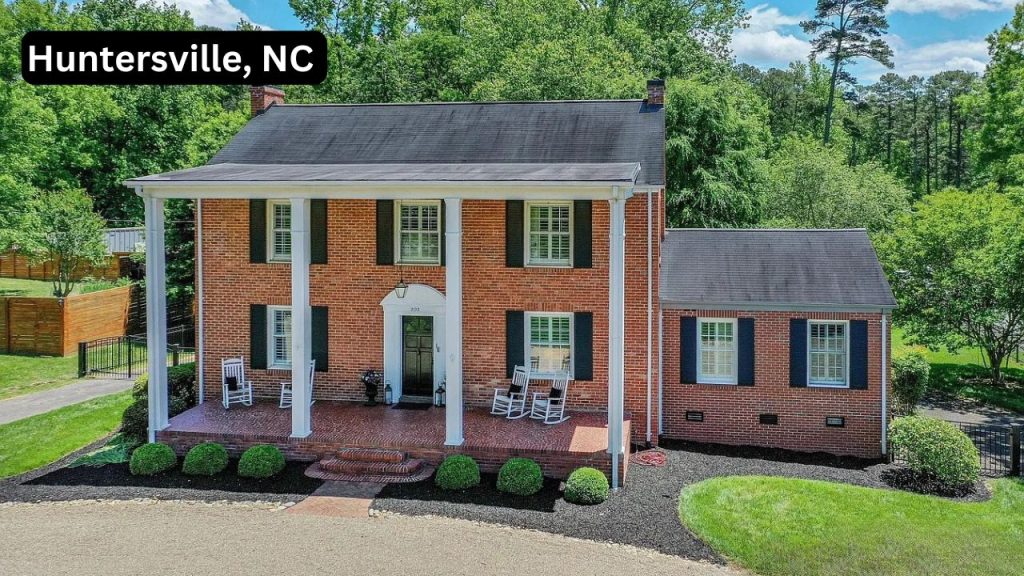 Colonial-style brick home with white columns and a front porch in Huntersville, NC.