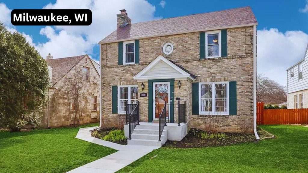 Brick colonial-style home in Milwaukee with green shutters and a front porch.