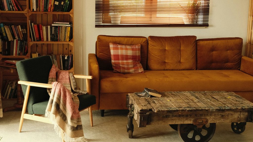 a living room with a couch, chair, coffee table and bookshelf