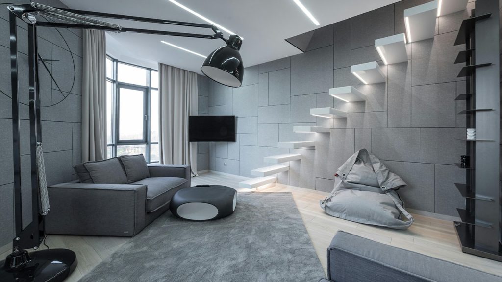 Studio with sofa on carpet and lamp with stairs