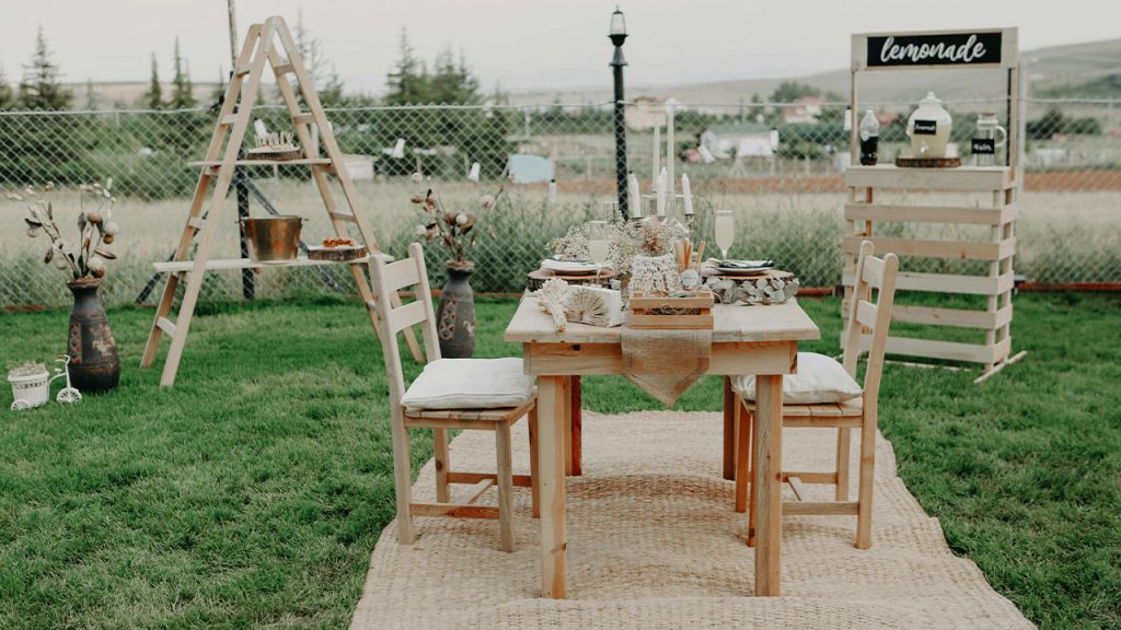 Brown Wooden Table With Chairs on Green Grass Field