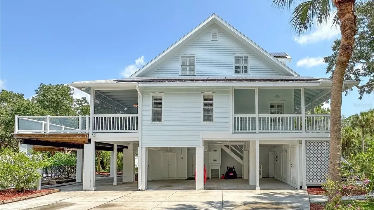 Tour This Stunning 1992 4-Bedroom Key West Style Home with Wraparound Porch in Oldsmar, FL (Floor Plan Included)