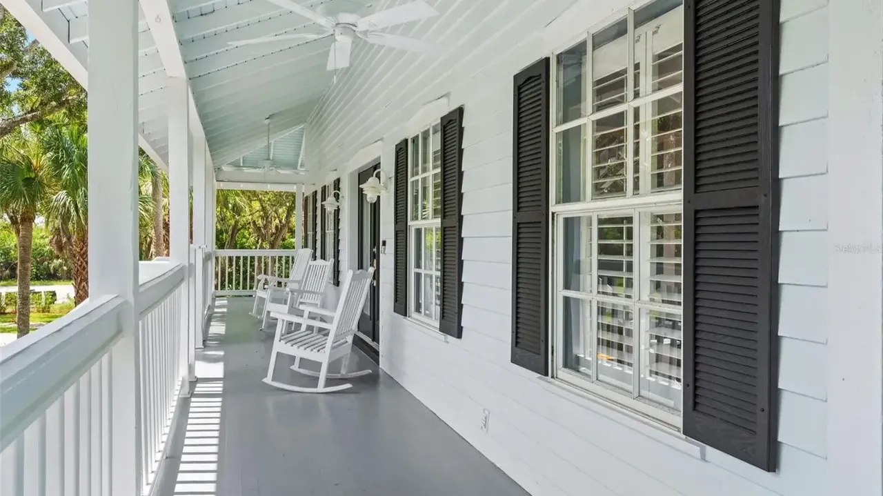 Tour This Stunning 1992 4-Bedroom Key West Style Home with Wraparound Porch in Oldsmar, FL (Floor Plan Included)