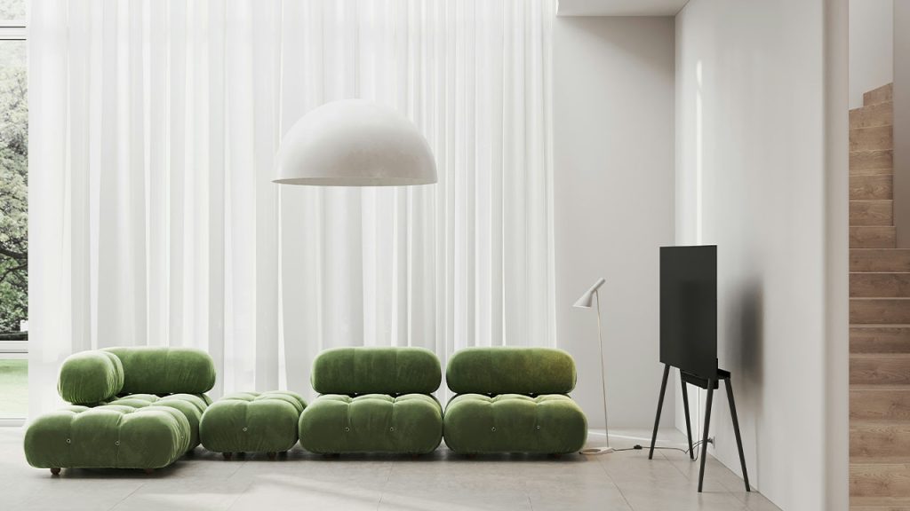 a living room with a green couch and a white lamp
