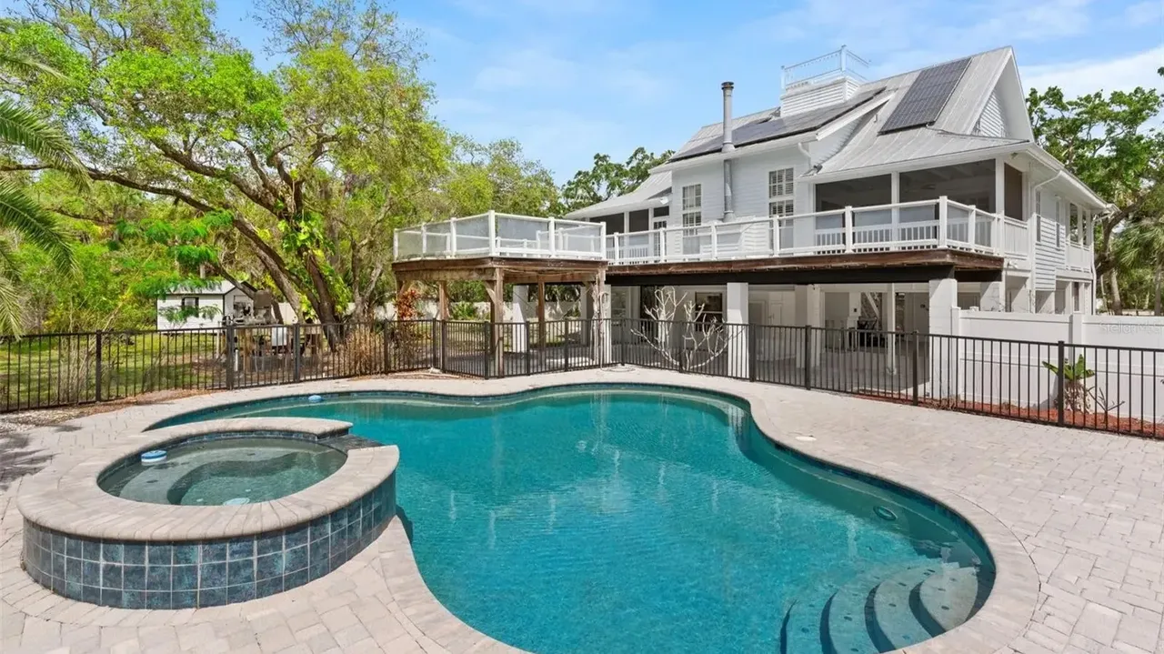 Tour This Stunning 1992 4-Bedroom Key West Style Home with Wraparound Porch in Oldsmar, FL (Floor Plan Included)