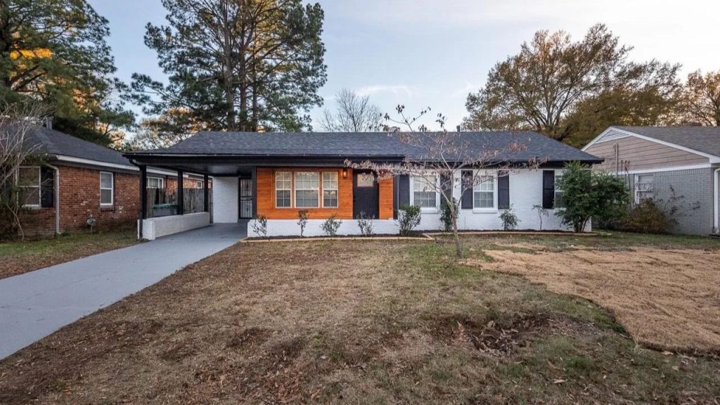 Brick and wood-accented ranch home with covered carport in Memphis.