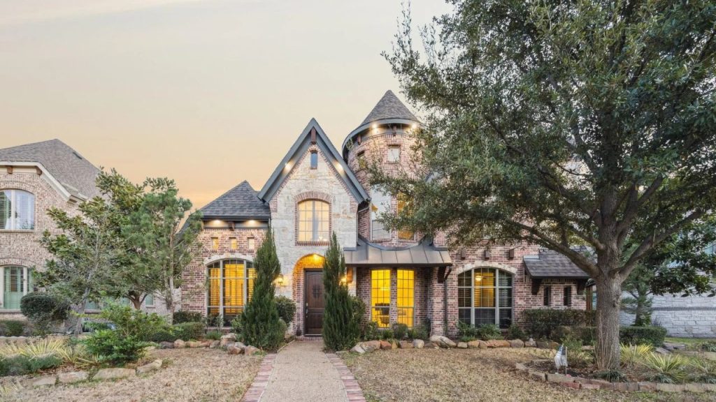 Fairytale-style brick home with turret and arched entry in Allen, TX.