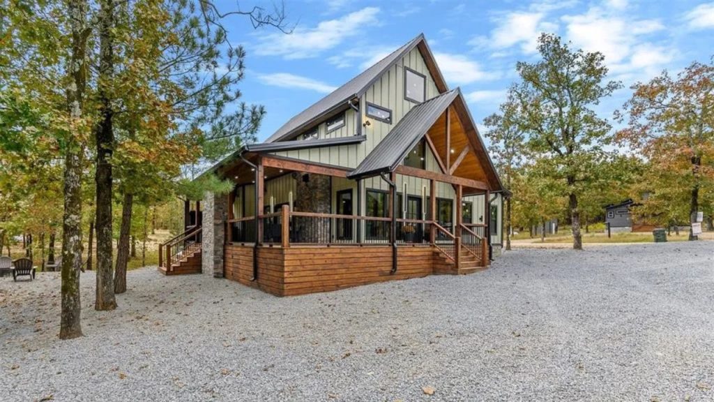 Wraparound porch cabin surrounded by trees in Broken Bow, OK.