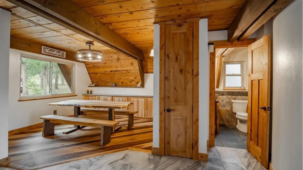 Cozy wood-paneled dining area with built-in cabinets and rustic bench seating.