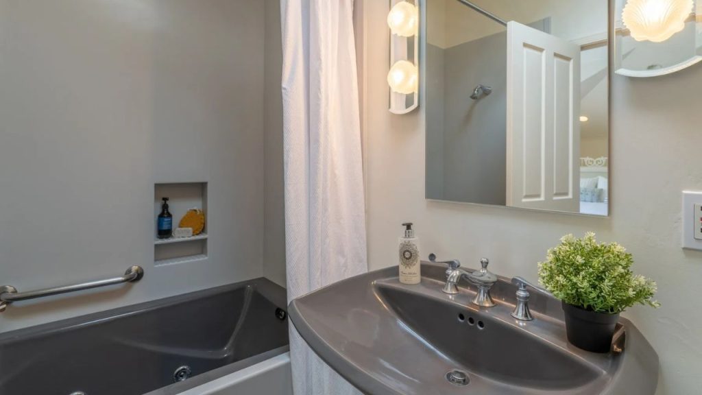 A calming bathroom with a sleek tub and modern vanity.