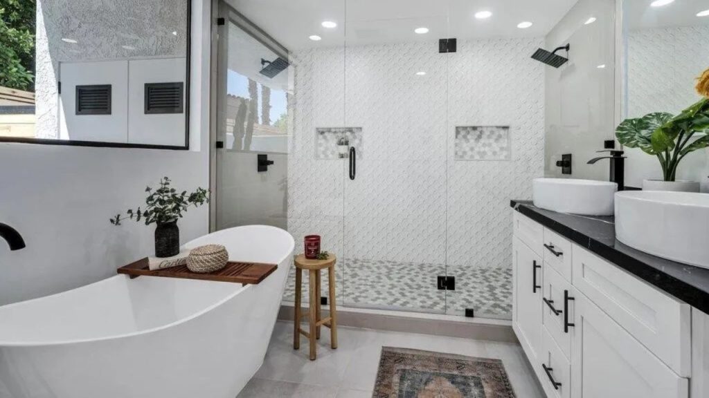 A luxurious bathroom with a freestanding tub, double vanity, and glass shower.