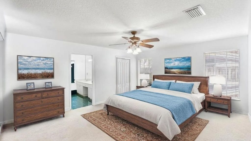 A serene bedroom with a wooden bed, blue bedding, and coastal artwork.