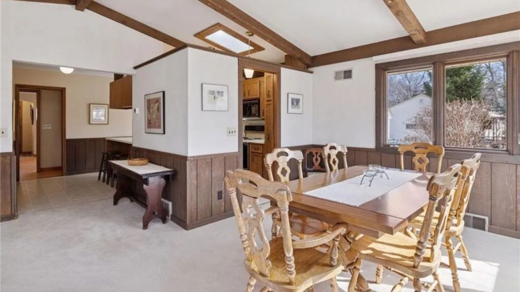 Bright Midwestern dining room with wood accents and exposed ceiling beams.