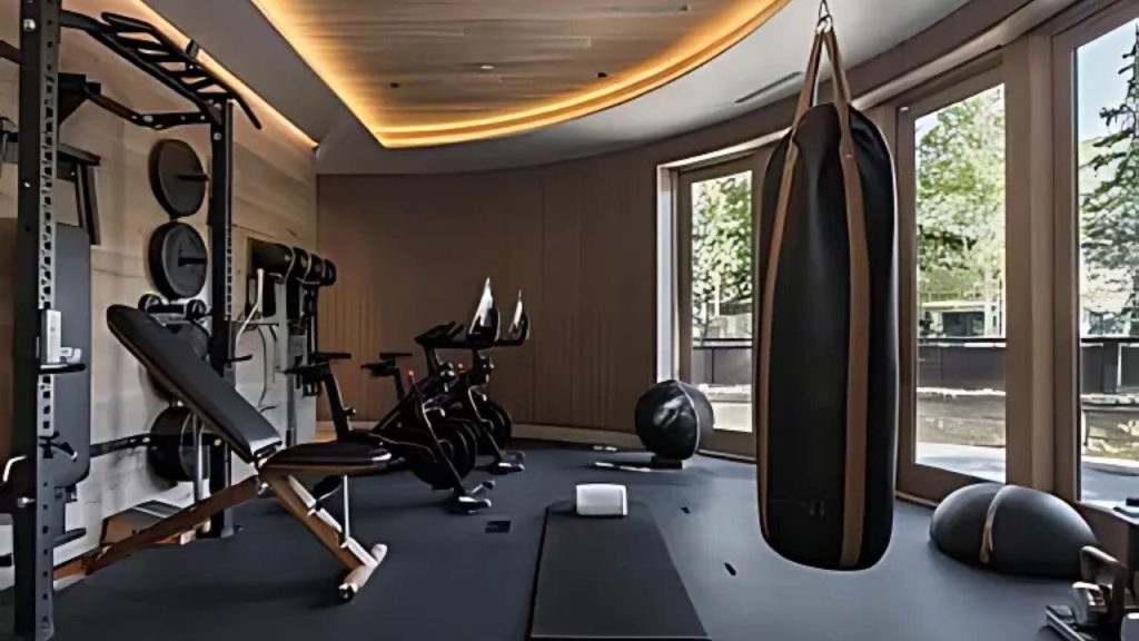 Stylish home gym with workout gear and large windows.