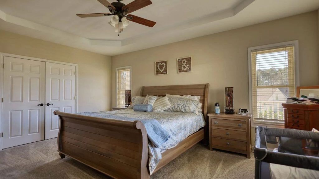 Warm-toned bathroom with orange curtain and white vanity.