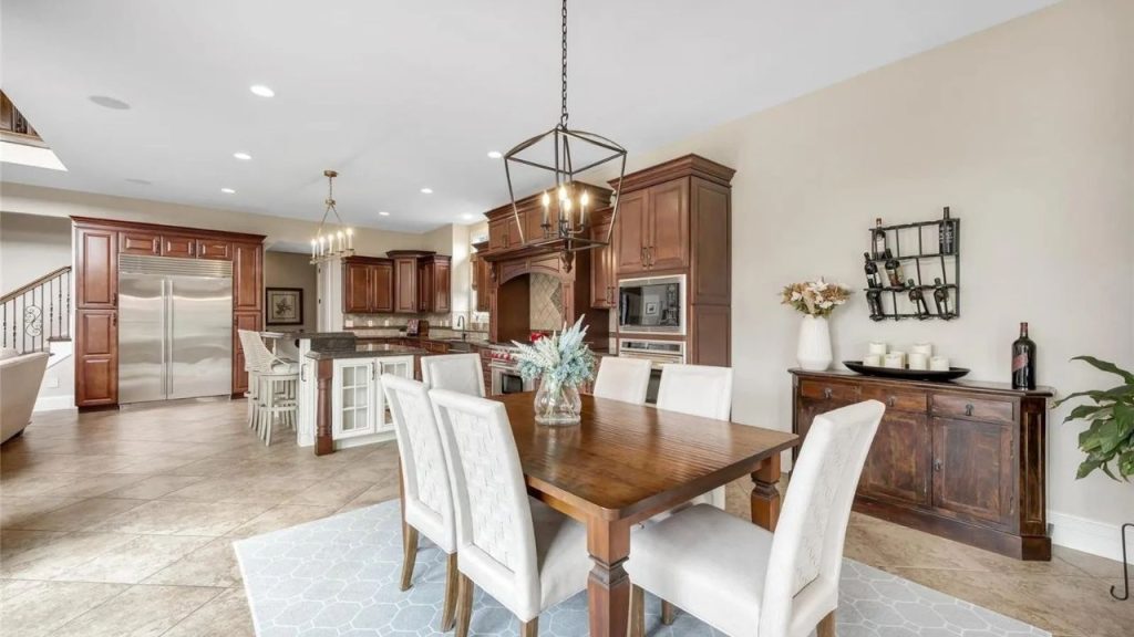 A warm and elegant kitchen and dining area with rich wood cabinetry and a spacious layout.