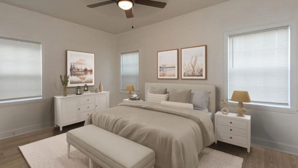 A serene bedroom with a plush bed, white nightstands, ceiling fan, and tranquil wall art.