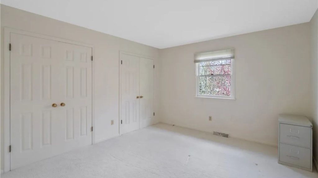  Minimal bedroom with double closets and soft carpet.