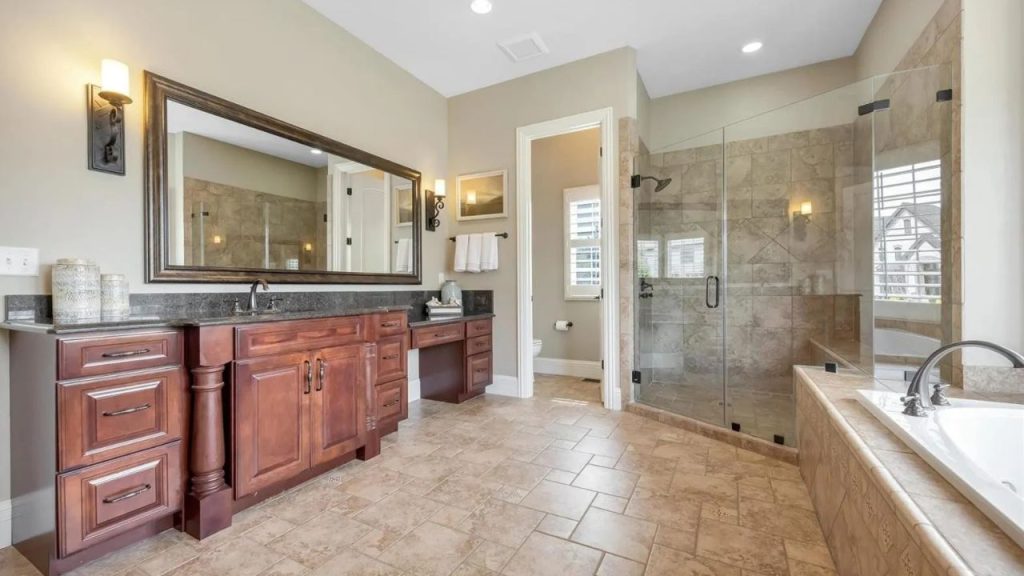 A spacious, elegant bathroom with a double vanity, walk-in shower, and soaking tub.