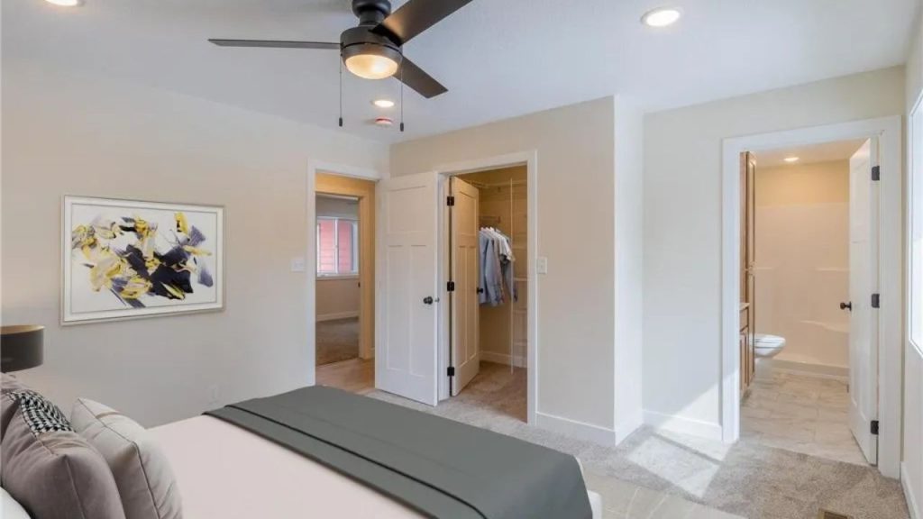 Bright bedroom with ceiling fan, walk-in closet, and ensuite bathroom.