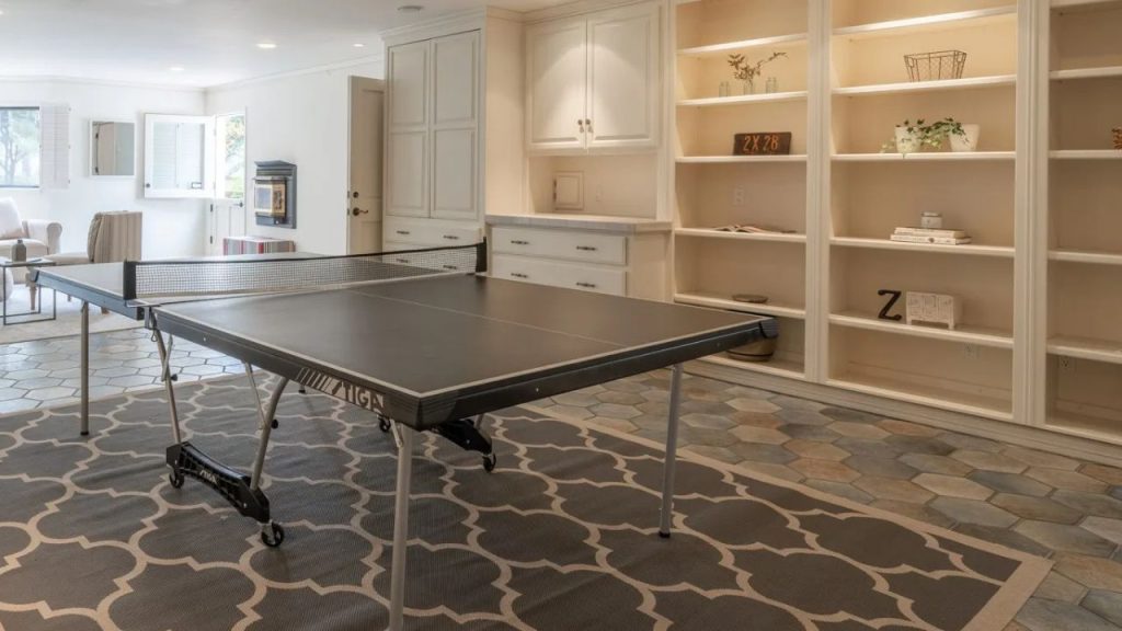 A lively game room featuring a ping pong table and built-in storage.
