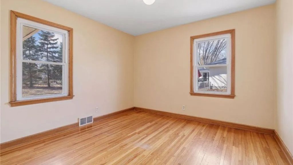 Cozy bedroom with hardwood floors and lots of natural light.