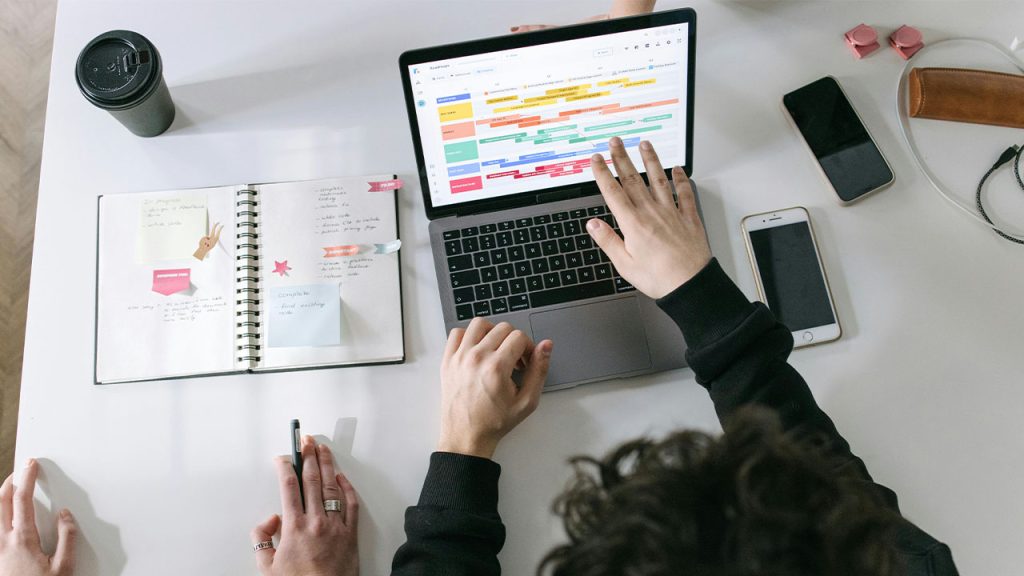 Person in Black Long Sleeve Shirt Using Macbook Pro