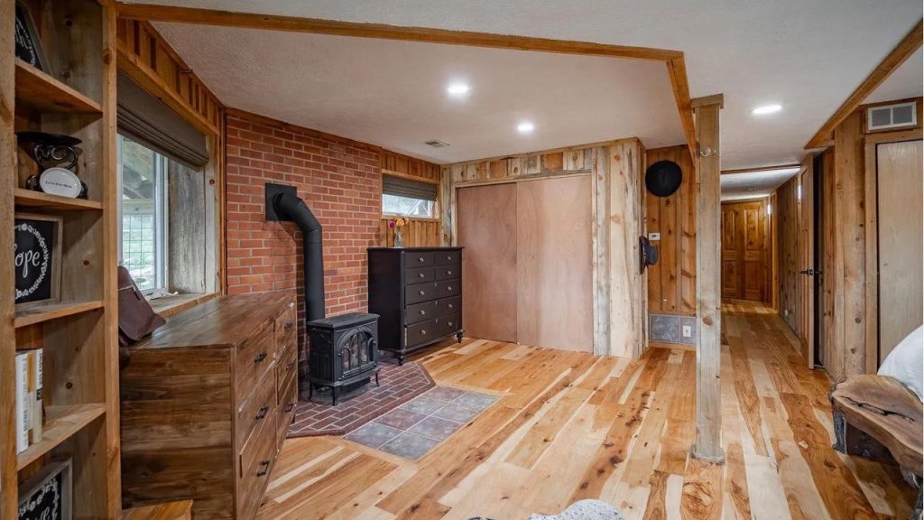 Rustic room with wood paneling, wood stove, and warm cabin details.
