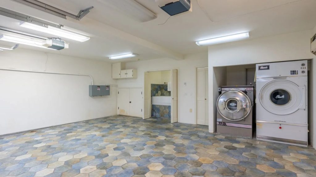 A bright laundry area with modern appliances and unique flooring.