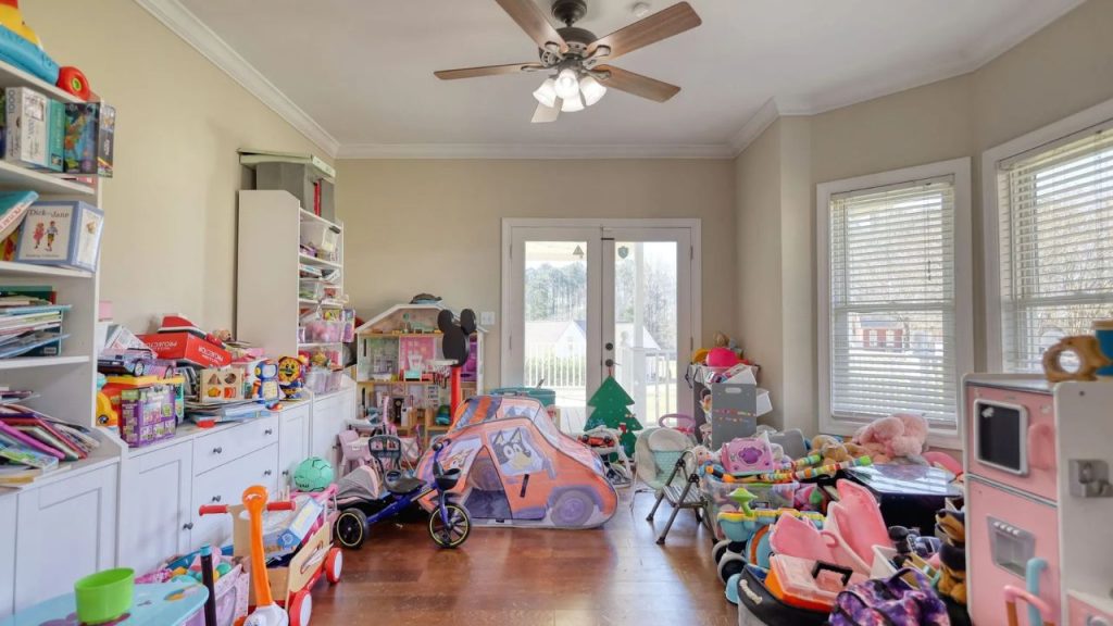 Colorful playroom full of toys, shelves, and natural light.