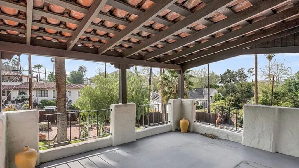 Spanish-style balcony with clay roof tiles and stucco railing.