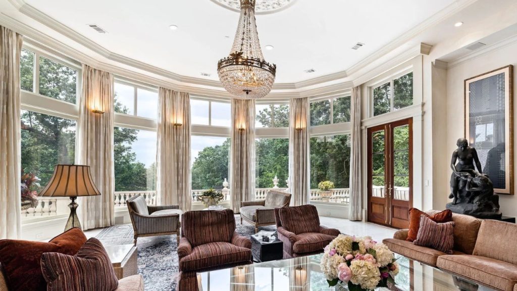 Bright and elegant lounge with floor-to-ceiling windows and a crystal chandelier.